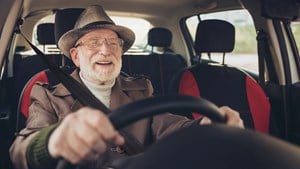 Man driving car in traffic jam holding steering wheel 