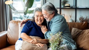 Senior retired couple talking together on the sofa