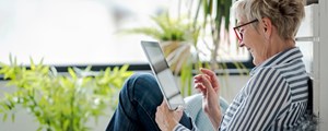 Senior woman using digital tablet at home.