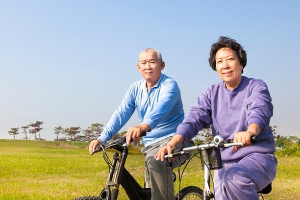 Couple riding bicycles in the countryside