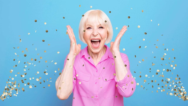 Happy woman holding her face in surprise