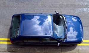 Blue car illegally parked on double yellow lines