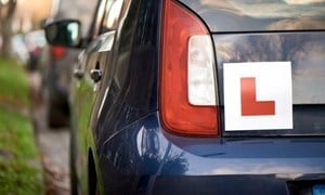 L plate on the back of a blue car