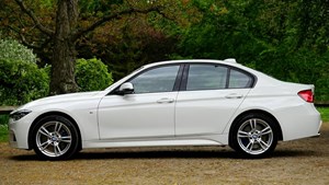 A four seater silver car parked outdoors.