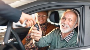 00113 - Couple in new car being handed the keys by a dealer - 16_9