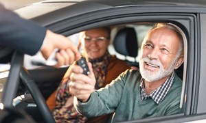 00113 - Couple in new car being handed the keys by a dealer - 5_3