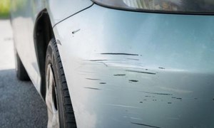 Close-up of scratched car bumper