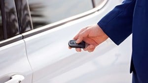 Hand holding key to open car door