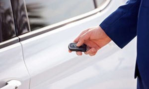 Hand holding key to open car door