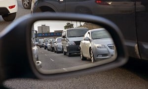 Line of motorway traffic viewed in car wing mirror