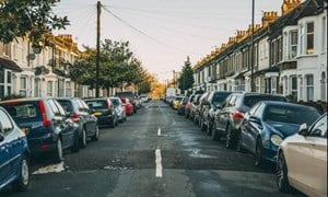 Parked cars either side of a residential street