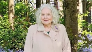 Lillian posing in a wood for her poetry collection.