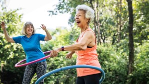 Ladies laughing using hula hoops