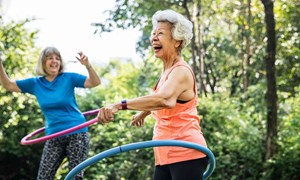 Ladies laughing using hula hoops