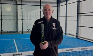 Glenn (63) with padel racket and on the court. 