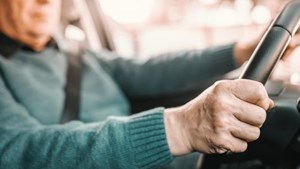 Close up of person driving a car