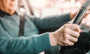 Close up of person driving a car