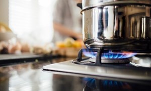 Saucepan on a lit gas kitchen stove