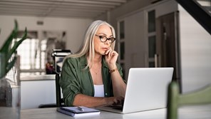 Woman working at desk on laptop