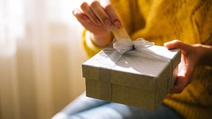 Present with ribbon being unwrapped