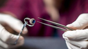 Sapphire ring being examined for valuation