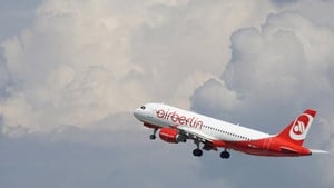 A plane takes off on a cloudy day.