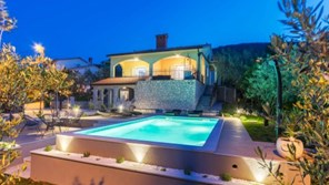 Lit up pool of a luxury villa