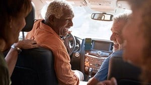 Group of friends in a car laughing