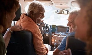 Group of friends in a car laughing