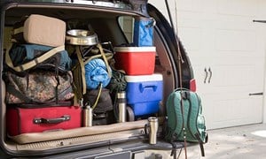 Car boot fully loaded with carefully placed bags and boxes