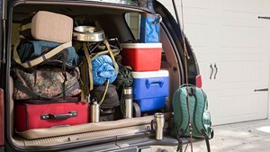 Car boot fully loaded with carefully placed bags and boxes